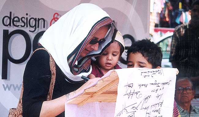 Design in Action: People participate in the mass signature campaign organised by Design & People on March 20, 2004  International Protest Day. The ten-meter cloth with thousands of signatures was sent to the US Ambassador to India David Mulford demanding an end to the military occupation of Iraq by the US and its allies. (Photo: Niranjan Das Sharma)